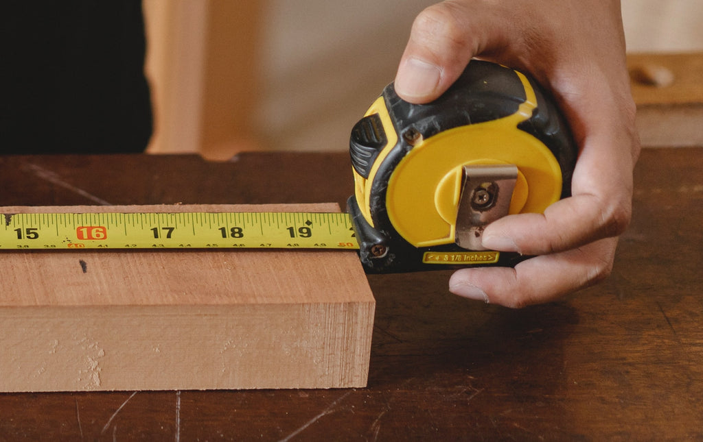 man holding a measuring tape during home repairs